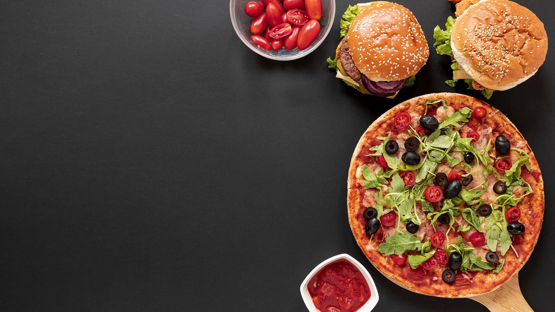 Fresh pizza with olives, rocket and cherry tomatoes